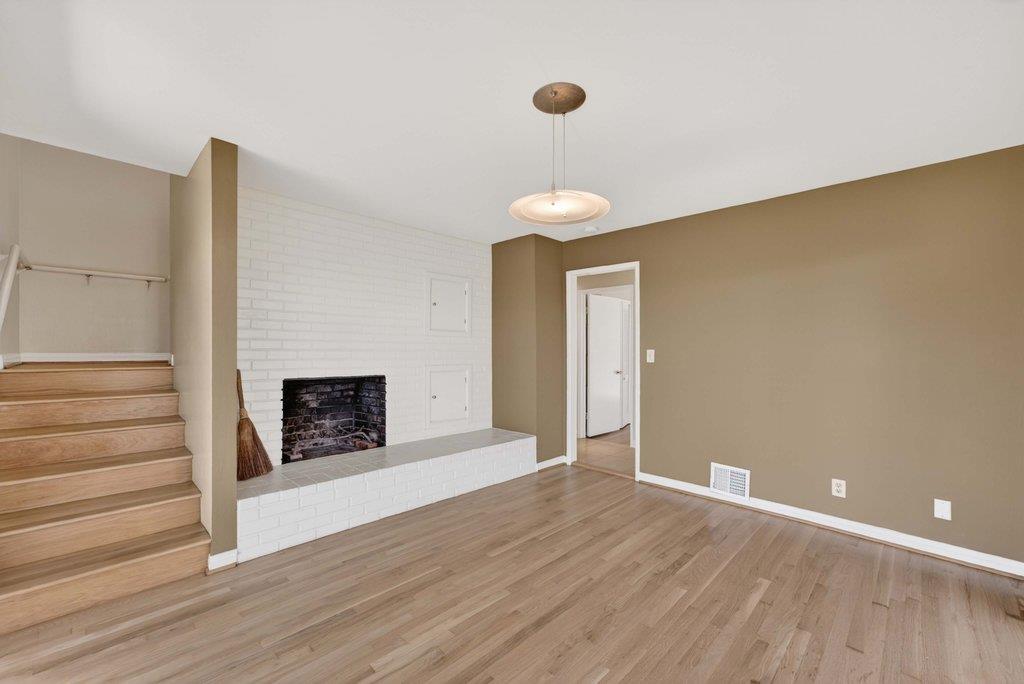 505 Hidden Valley Road Watsonville, CA 95076 - Photo 22 of 72 a view of a livingroom with wooden floor and a fireplace