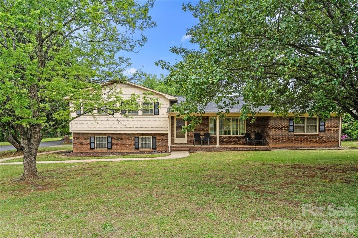 1527 Rhyne Street Shelby, NC 28152 - Photo 1 of 30 a view of a house with a big yard and large trees