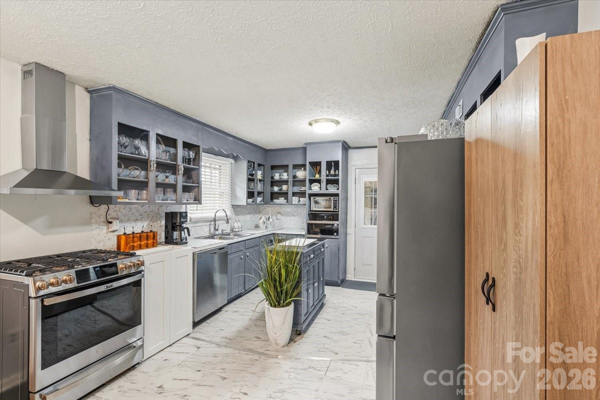 1527 Rhyne Street Shelby, NC 28152 - Photo 11 of 30 a kitchen with a refrigerator and a stove top oven