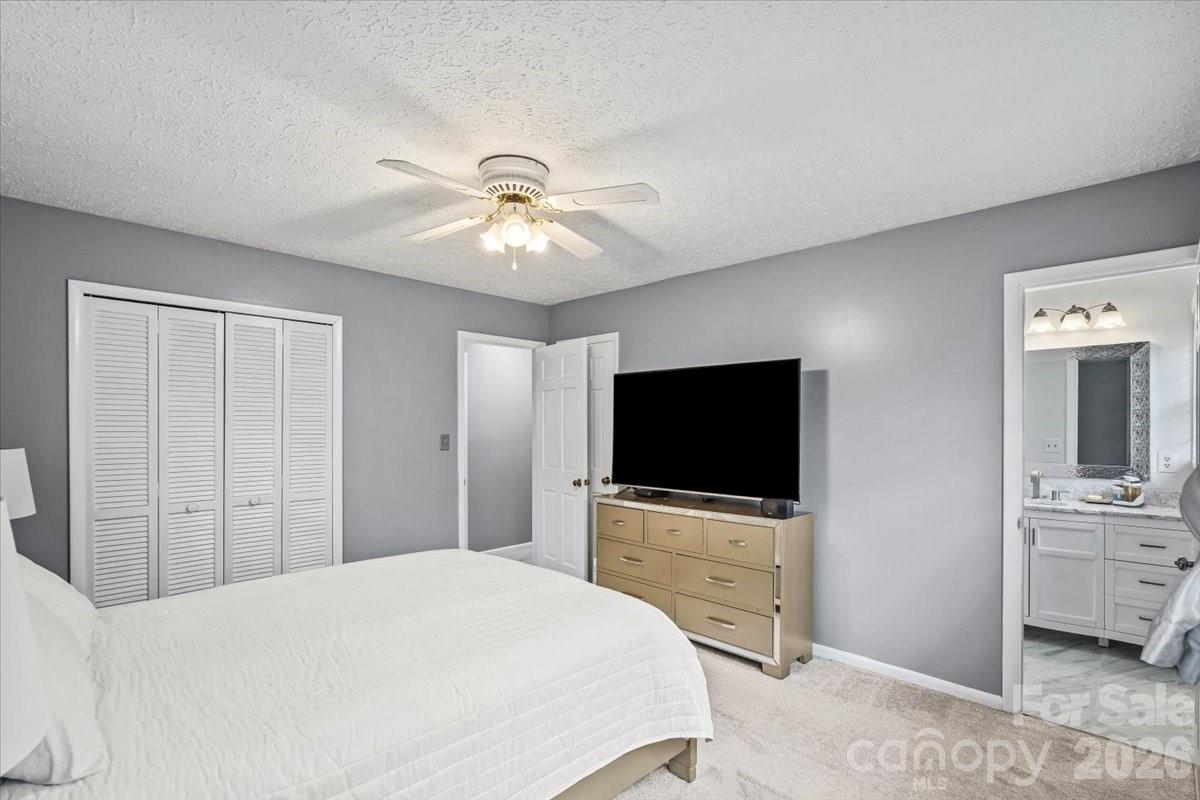 1527 Rhyne Street Shelby, NC 28152 - Photo 18 of 30 a bedroom with a bed and a flat tv screen on dresser