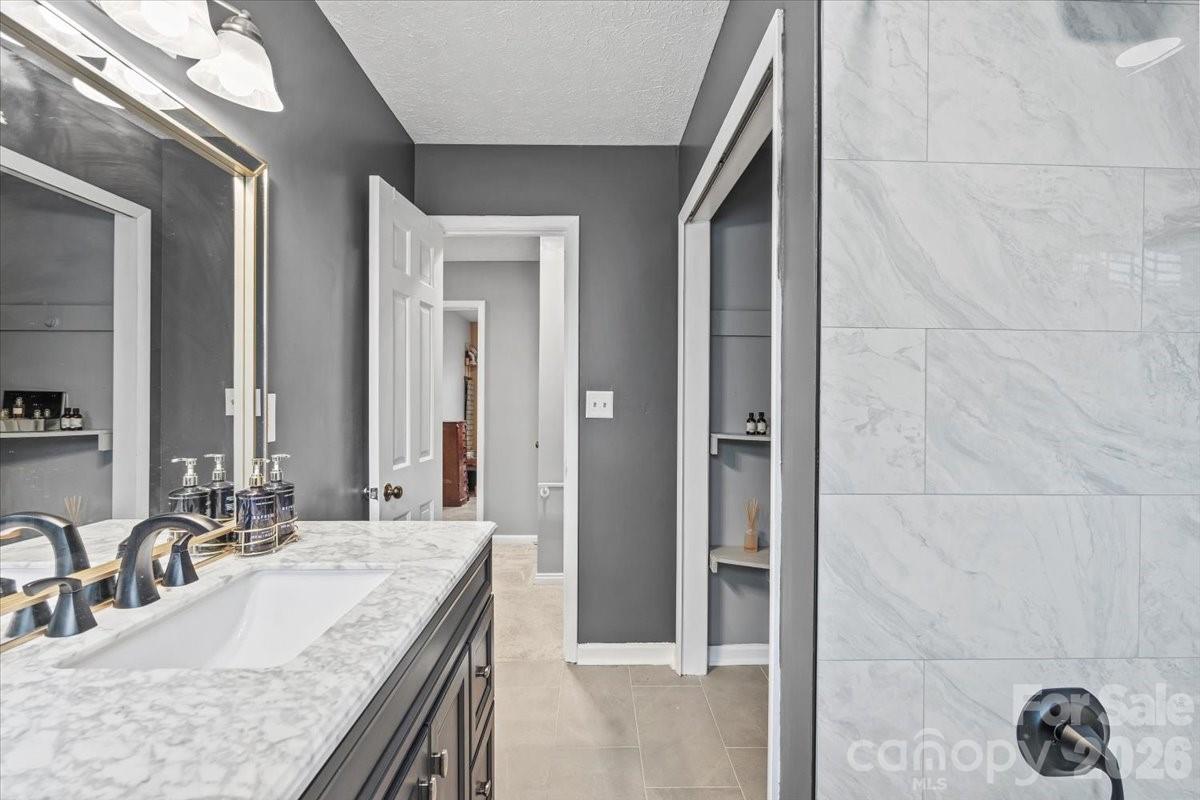 1527 Rhyne Street Shelby, NC 28152 - Photo 20 of 30 a bathroom with a granite countertop sink and a mirror