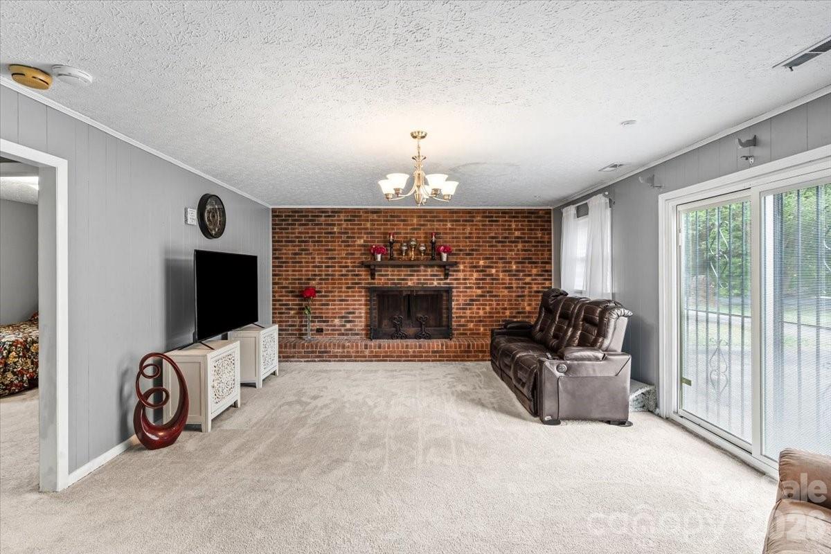 1527 Rhyne Street Shelby, NC 28152 - Photo 23 of 30 a living room with furniture and a fireplace