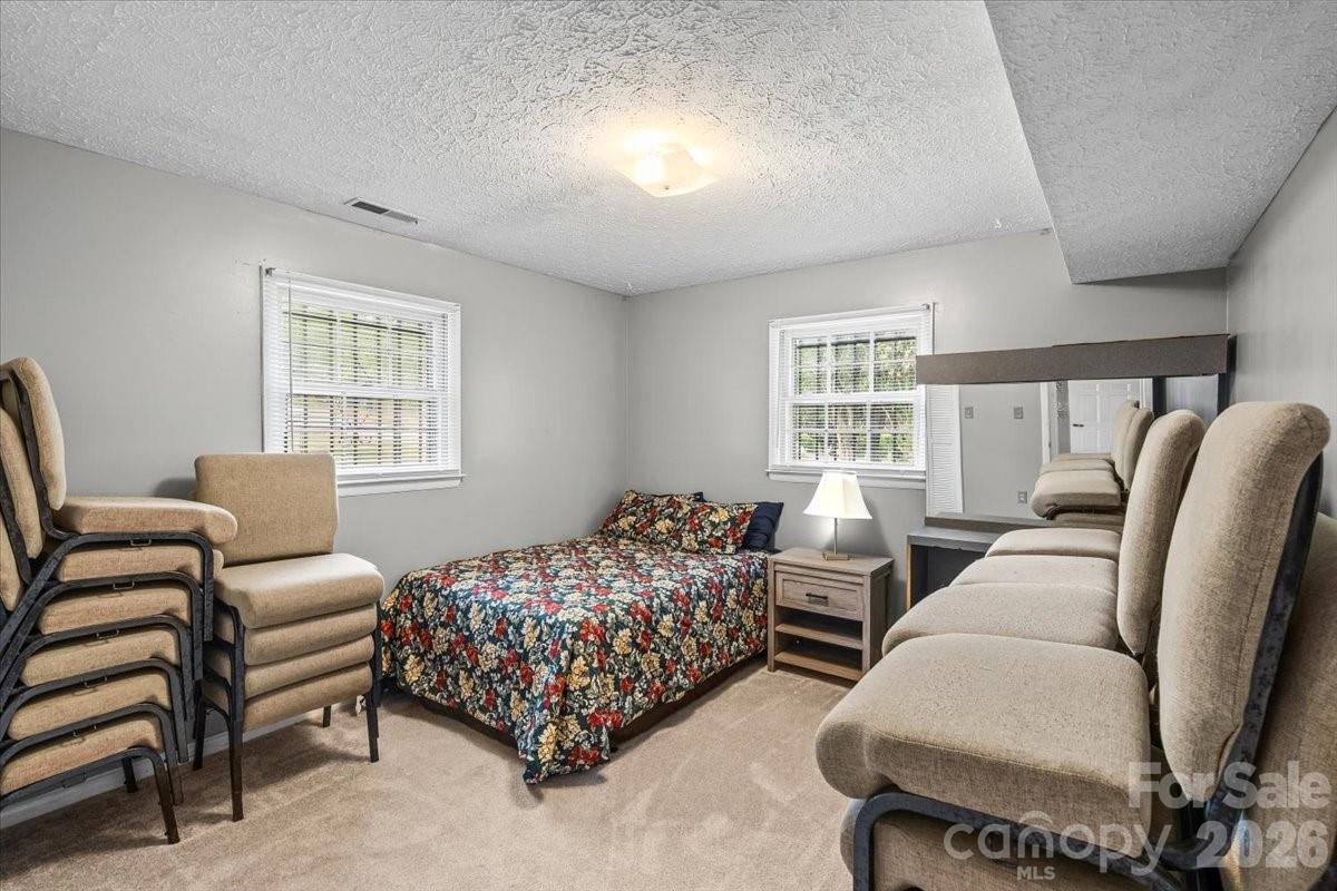 1527 Rhyne Street Shelby, NC 28152 - Photo 24 of 30 a bedroom with bed couch and window