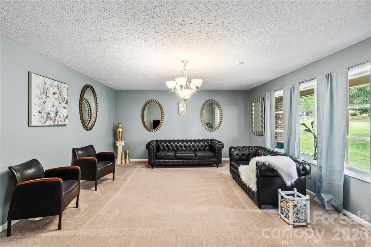 1527 Rhyne Street Shelby, NC 28152 - Photo 4 of 30 a view of a livingroom with furniture large windows and a chandelier