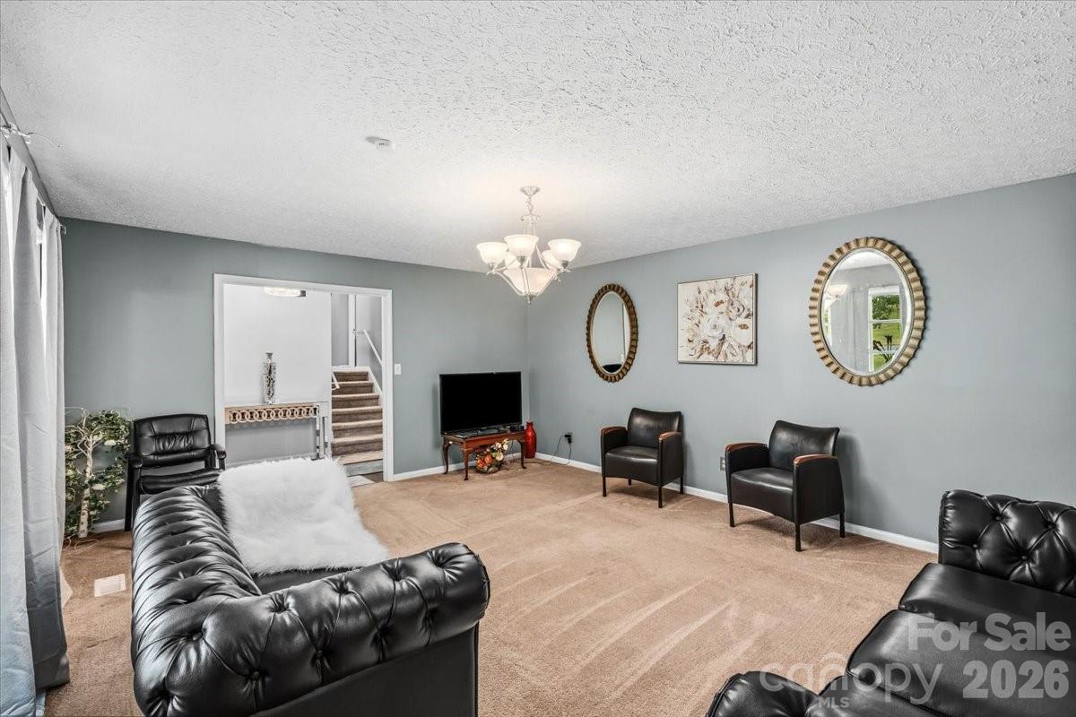 1527 Rhyne Street Shelby, NC 28152 - Photo 5 of 30 a living room with furniture a mirror and a window