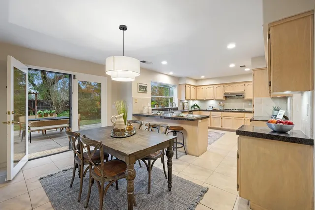a kitchen with a dining table and chairs