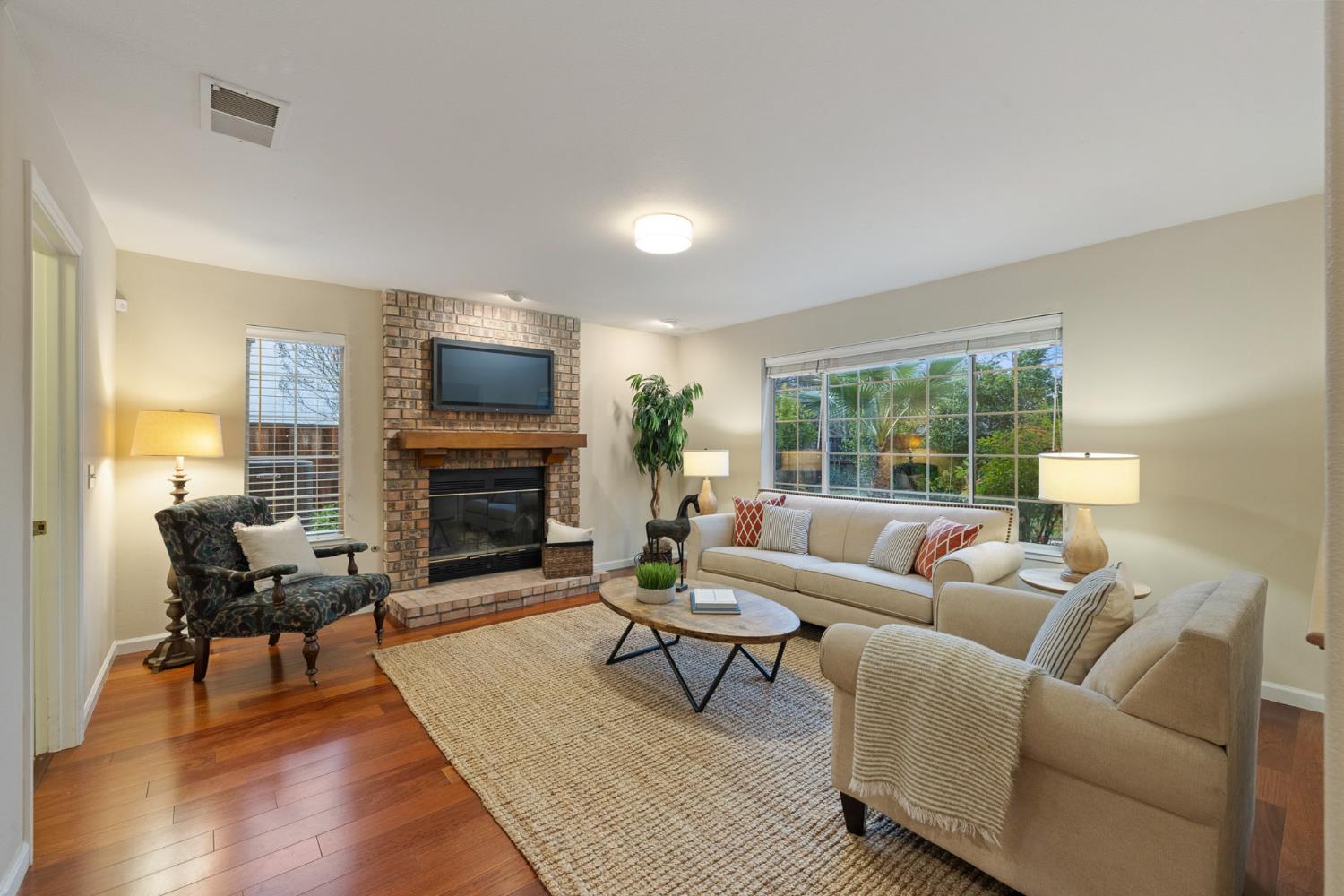 2309 O'Keeffe Pl. Davis, CA 95618 - Photo 18 of 57 a living room with furniture a fireplace and a flat screen tv