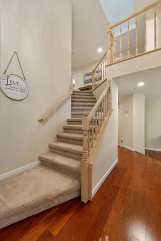 a view of entryway and hall with wooden floor