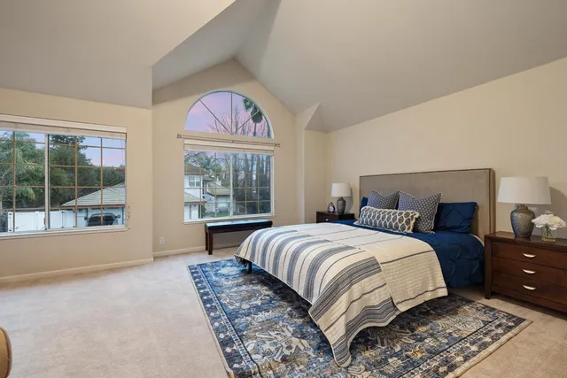 a bedroom with furniture and a flat screen tv
