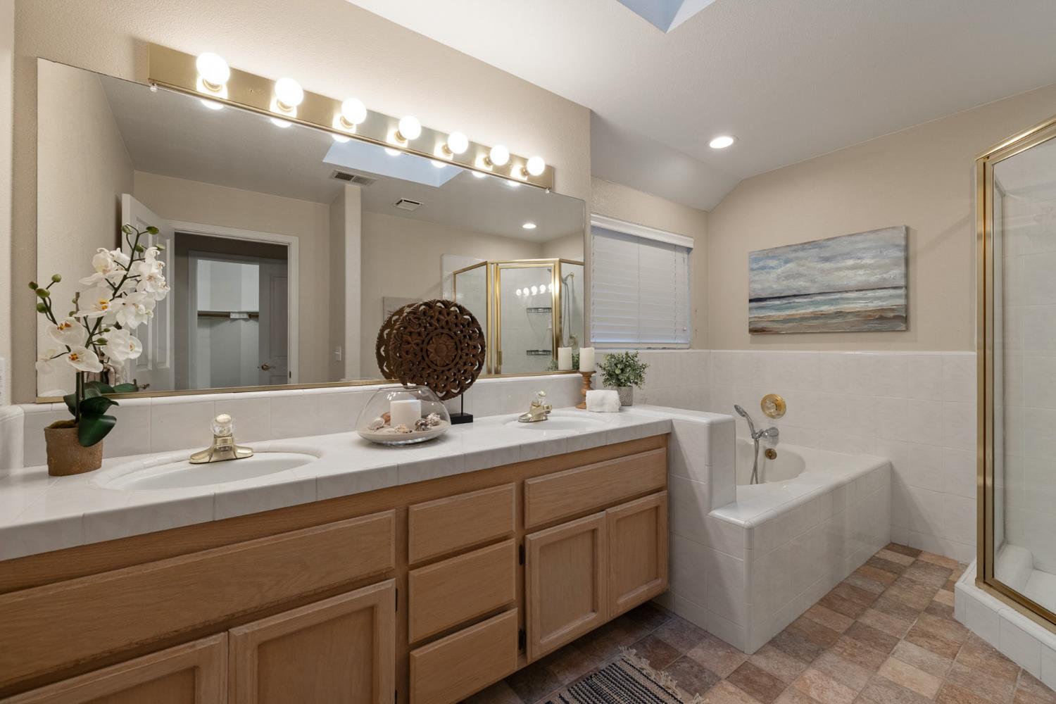 2309 O'Keeffe Pl. Davis, CA 95618 - Photo 27 of 57 a bathroom with a double vanity sink mirror and bathtub