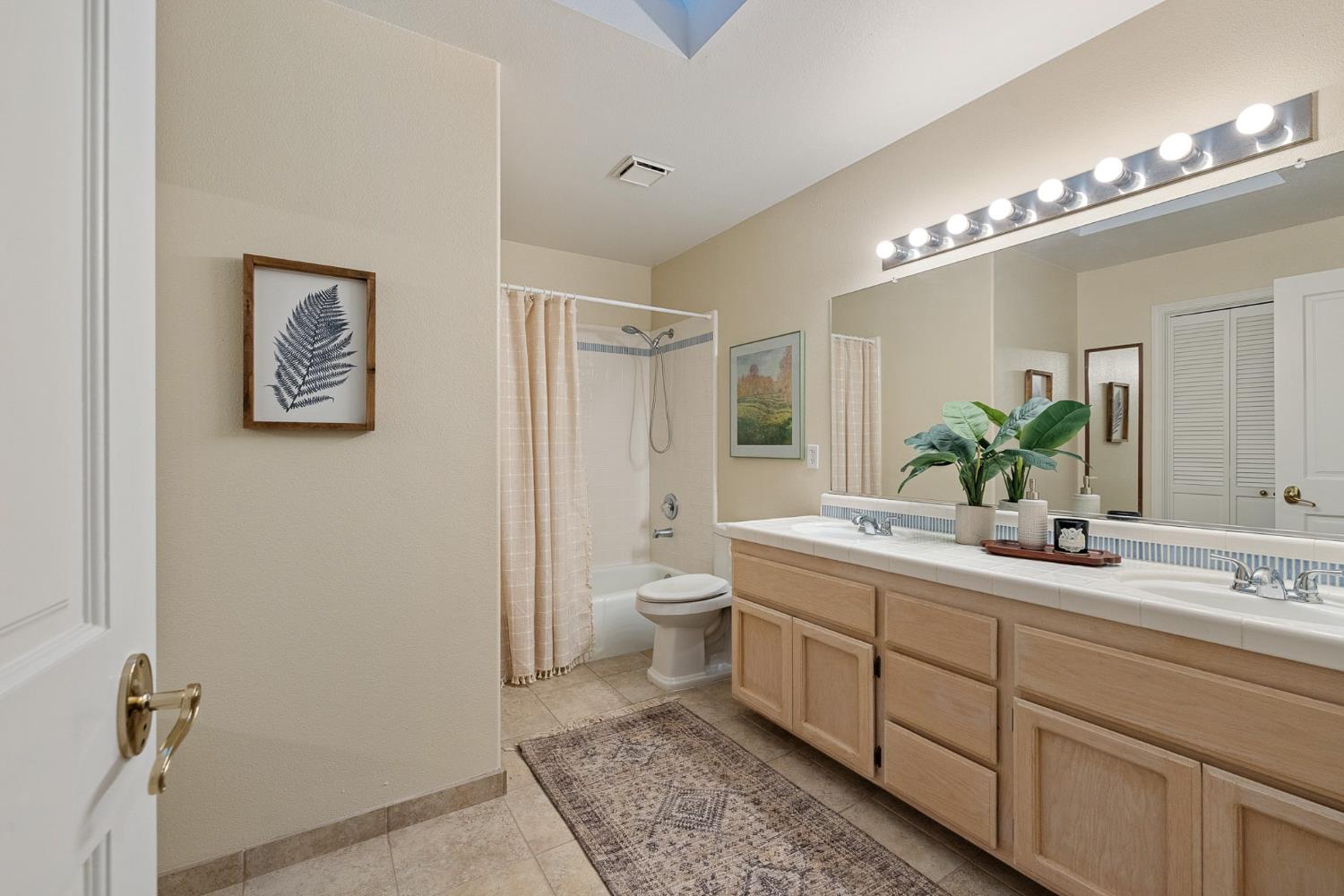 2309 O'Keeffe Pl. Davis, CA 95618 - Photo 35 of 57 a bathroom with a double vanity sink mirror and toilet