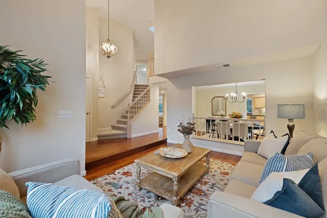 a living room with furniture and a potted plant