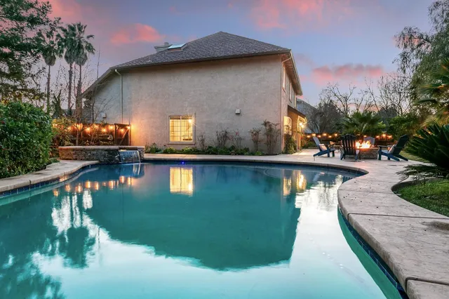 a view of a swimming pool with a yard