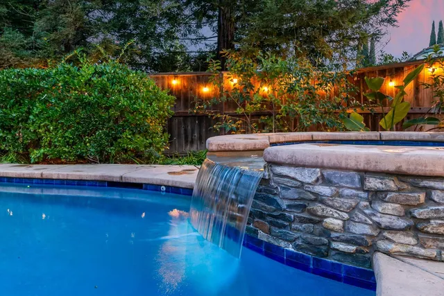 swimming pool view with a seating space