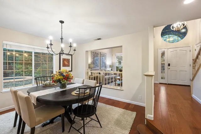 a view of a dining room with furniture window and wooden floor