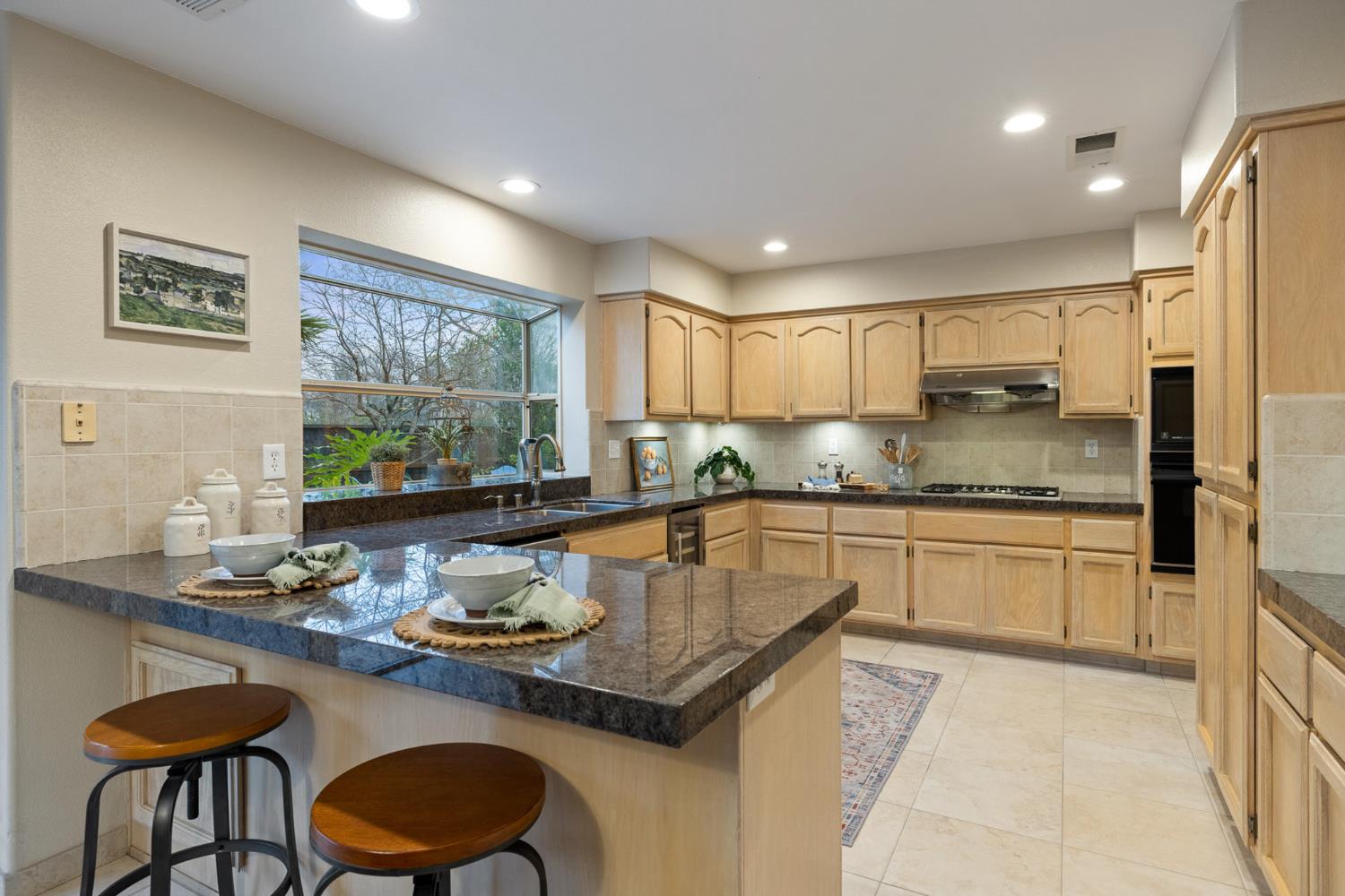 2309 O'Keeffe Pl. Davis, CA 95618 - Photo 10 of 57 a kitchen with granite countertop a sink stove and refrigerator