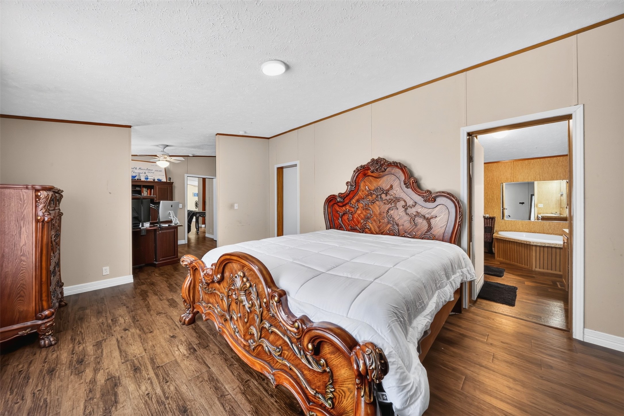 2581 Mann Road Conroe, TX 77303 - Photo 16 of 32 Spacious bedroom with wood-look flooring and room for additional furnishings.
