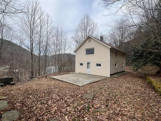 a view of a house with a yard covered in snow