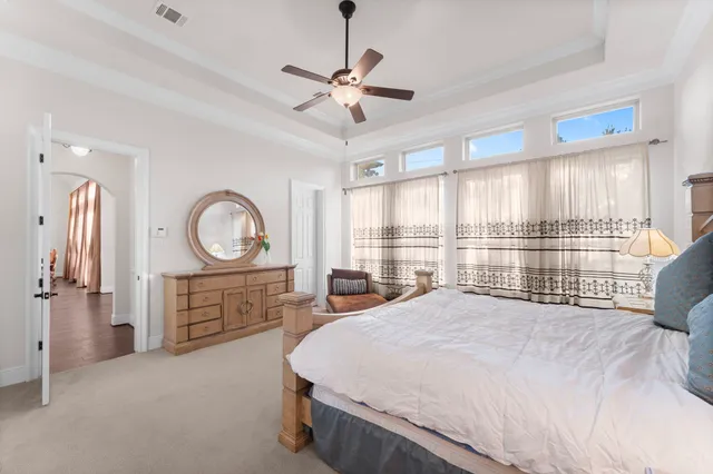 a bedroom with a large bed and a large window