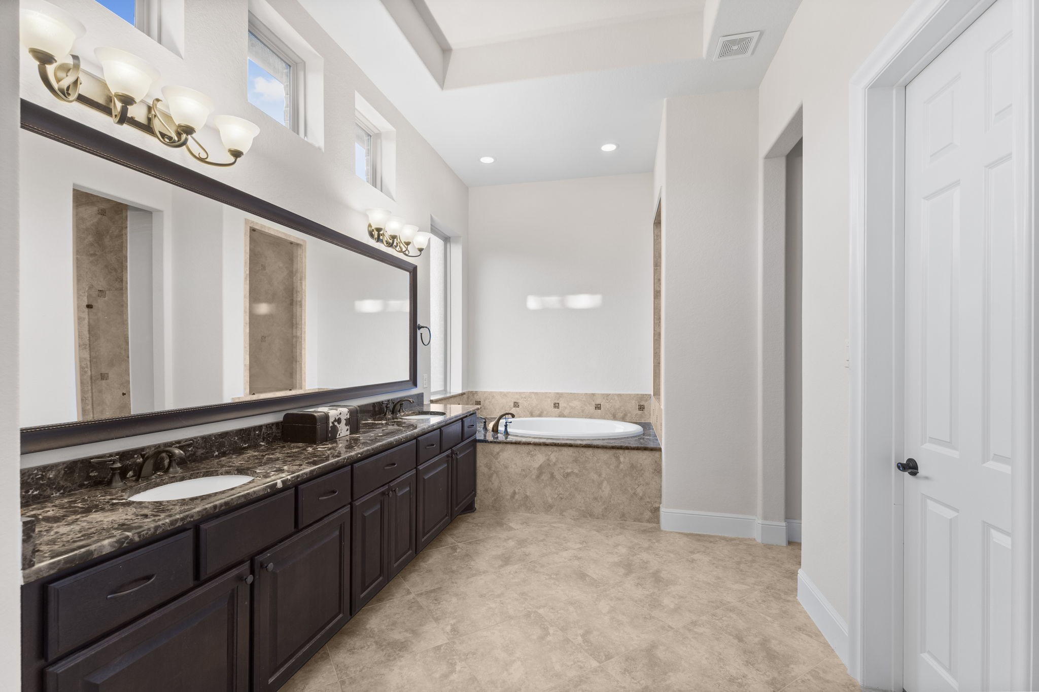 4022 Sabine Valley Trail Spring, TX 77386 - Photo 26 of 50 The primary bathroom is sleek, clean and doesn't feel like a sunless dungeon like so many do. Notice the small windows above the sinks providing beautiful light.