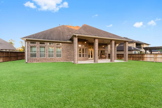 a view of a house with backyard porch and sitting area