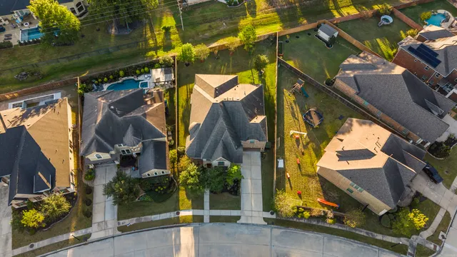 an aerial view of residential houses with outdoor space