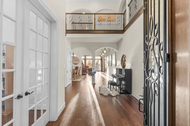 a view of a hallway with wooden floor and windows