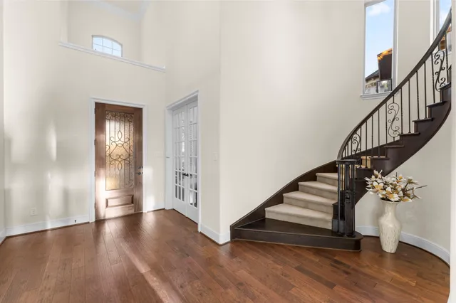 a view of an entryway with wooden floor and stairs
