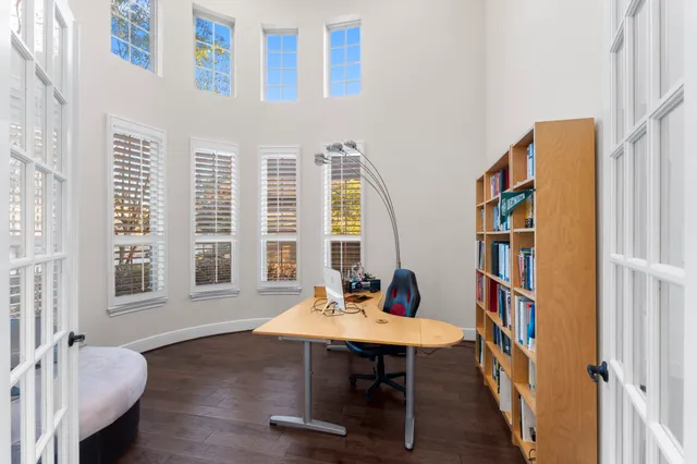 a view of a workspace with furniture and a window