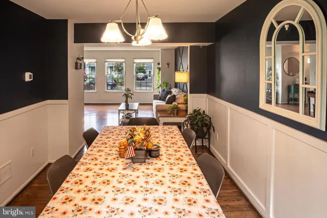 a living room with a large window and chandelier