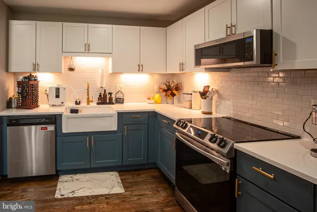 a kitchen with a sink stove and microwave
