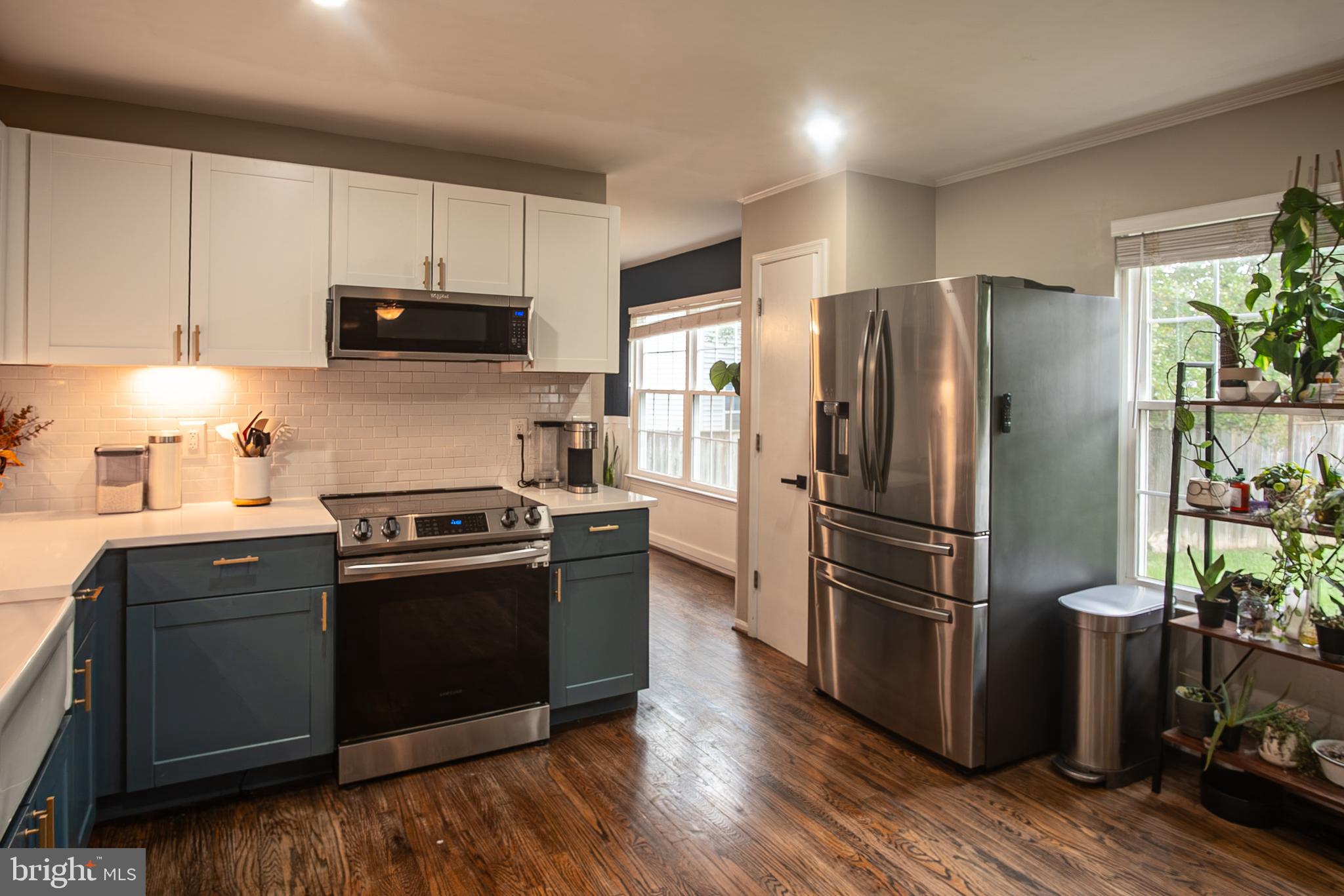 6621 Gooseander Court Frederick, MD 21703 - Photo 14 of 42 a kitchen with stainless steel appliances granite countertop a refrigerator stove and sink