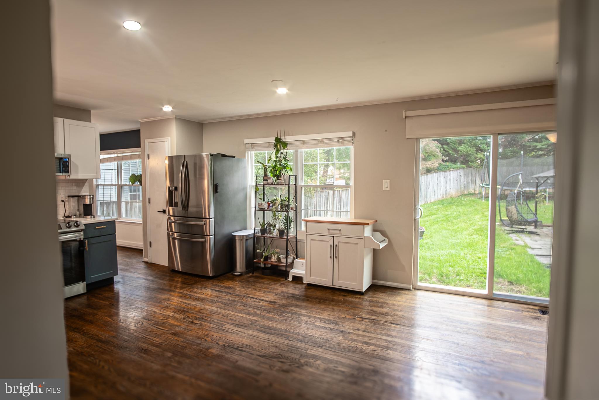6621 Gooseander Court Frederick, MD 21703 - Photo 17 of 42 a kitchen with stainless steel appliances a refrigerator and wooden floor