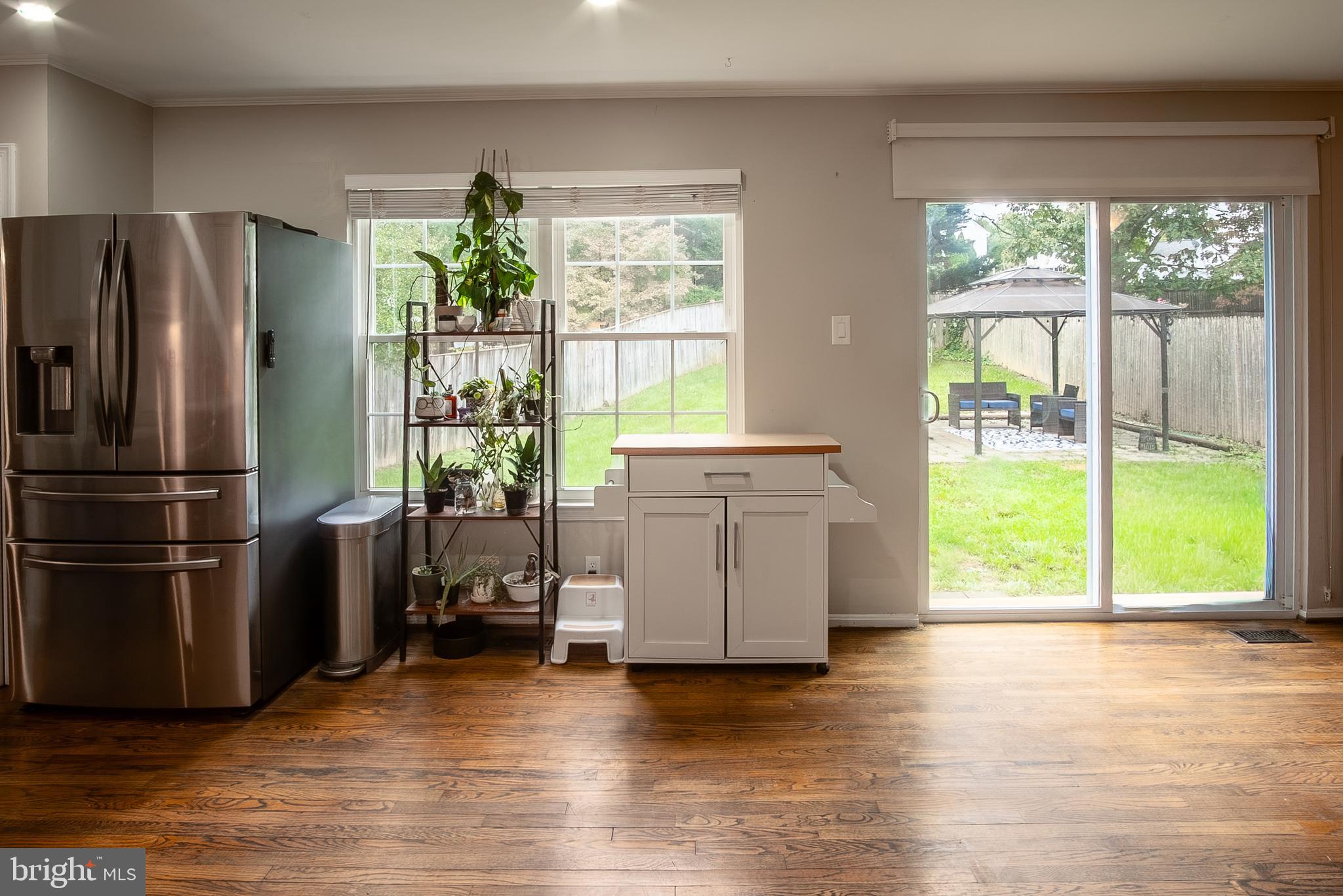 6621 Gooseander Court Frederick, MD 21703 - Photo 18 of 42 a kitchen with a refrigerator a stove and wooden floor