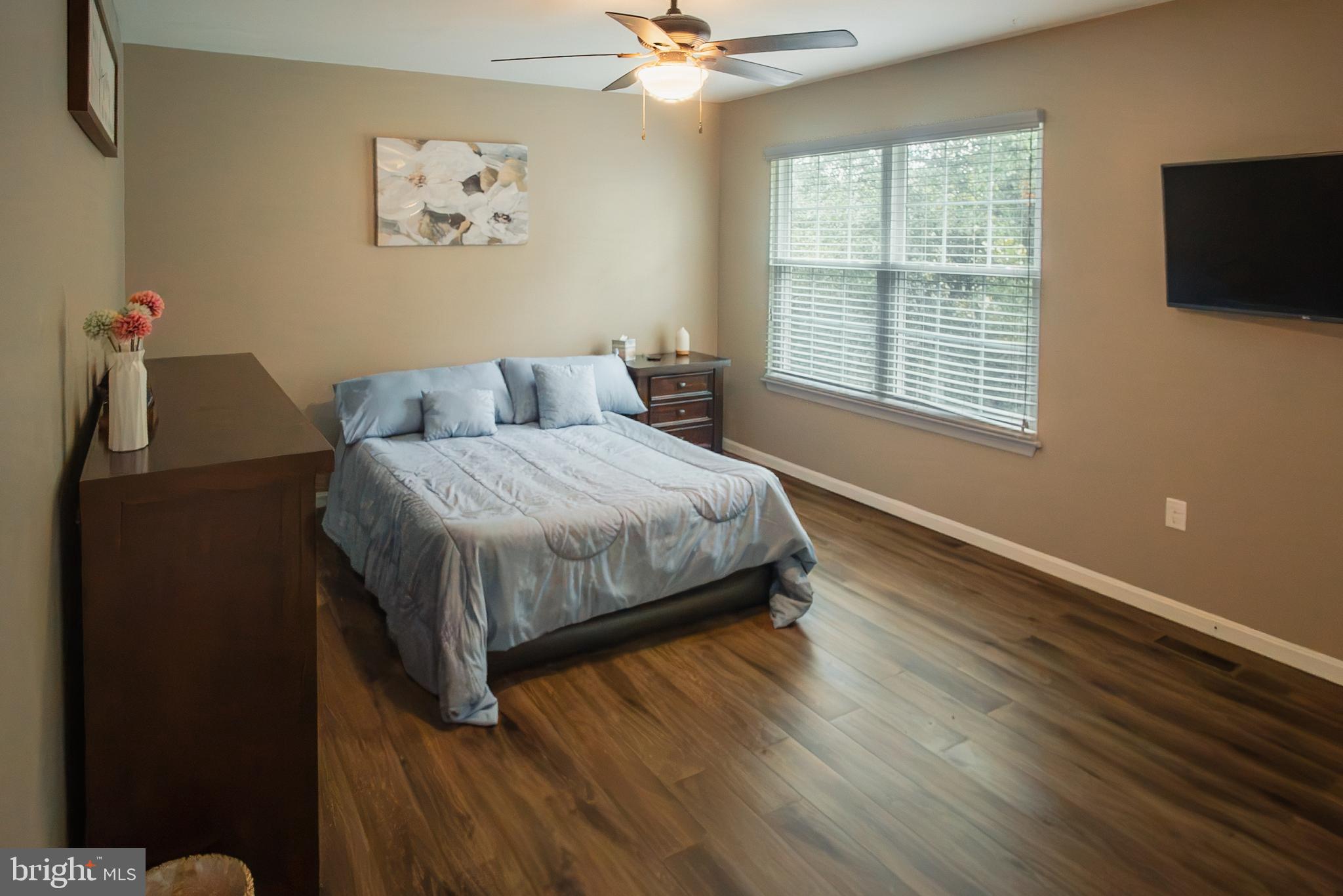 6621 Gooseander Court Frederick, MD 21703 - Photo 24 of 42 a bedroom with a bed and a flat screen tv