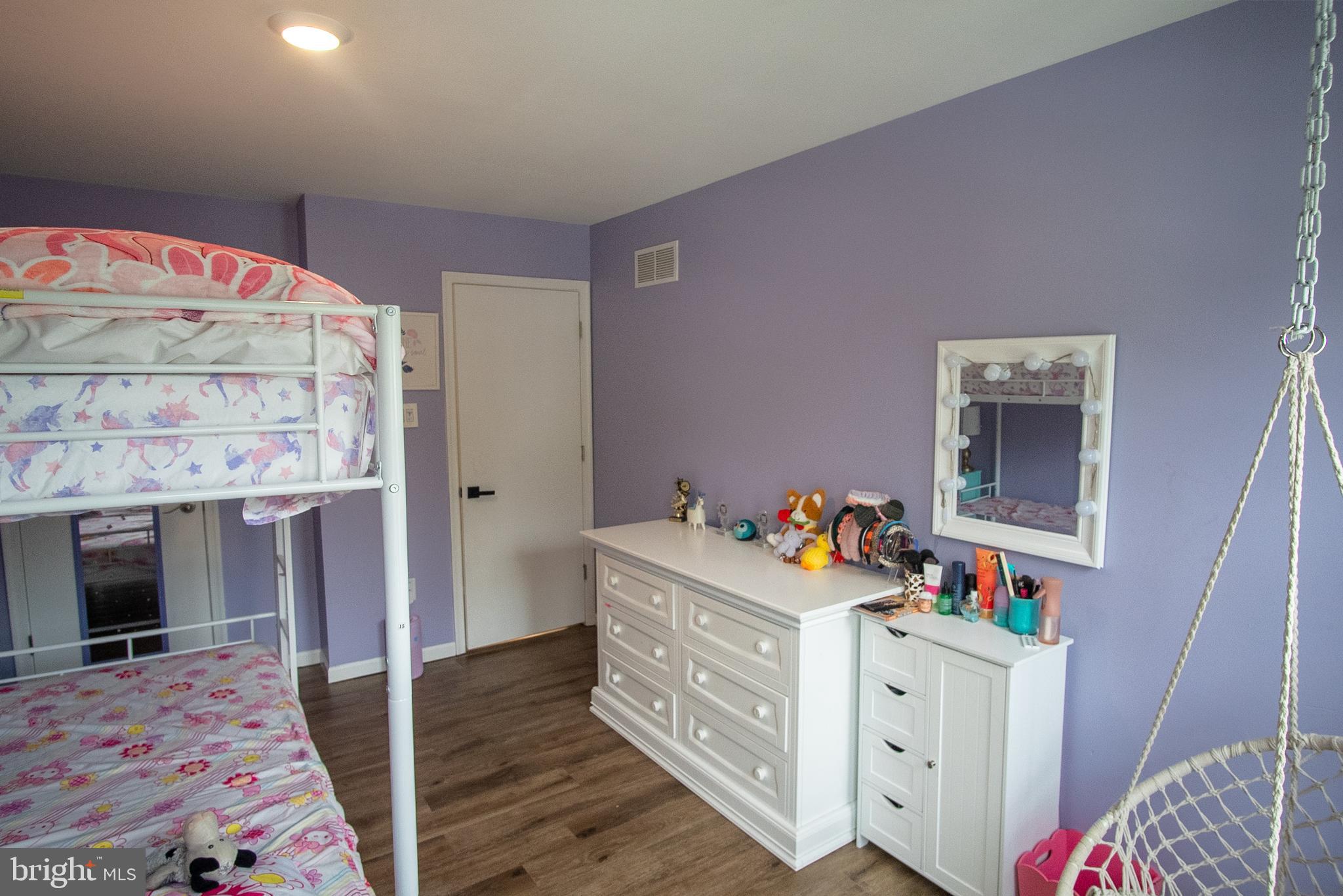 6621 Gooseander Court Frederick, MD 21703 - Photo 31 of 42 a bedroom with a bed and wooden floor