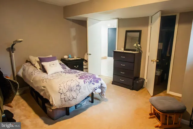 a bedroom with a bed and a chair