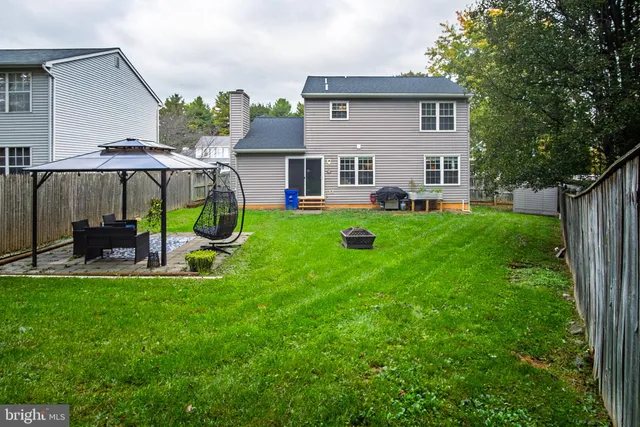 a view of a house with backyard sitting area and garden