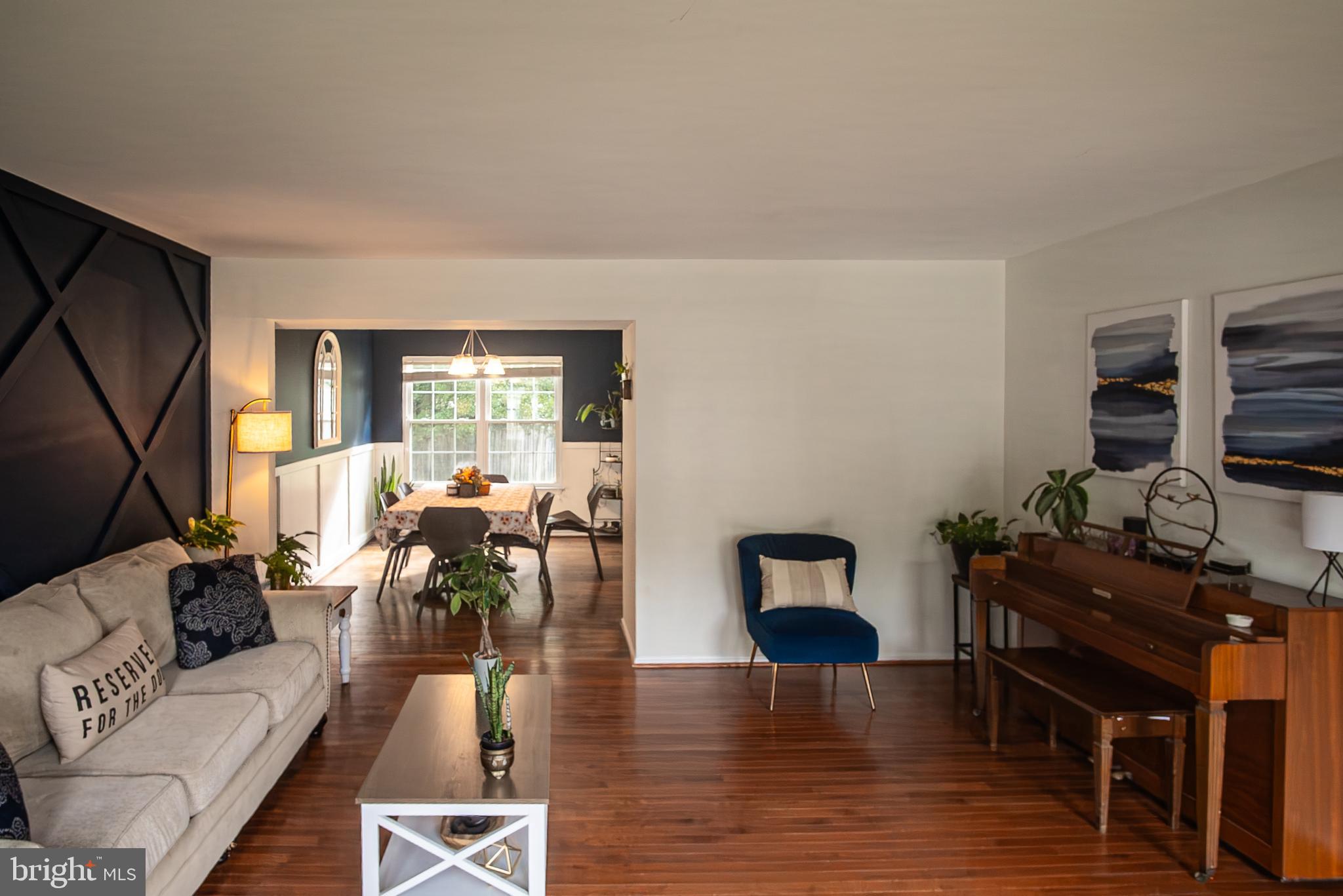 6621 Gooseander Court Frederick, MD 21703 - Photo 6 of 42 a living room with furniture flat screen tv and wooden floor