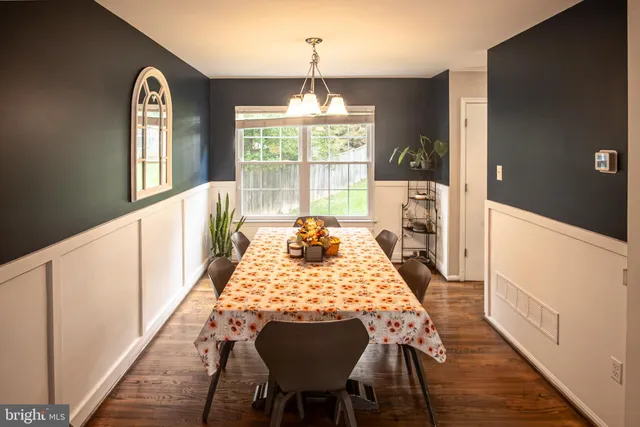 a view of a dining room with furniture and chandelier
