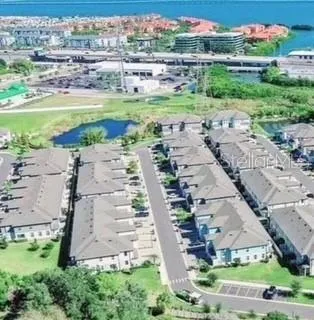 an aerial view of a house with a garden and lake view