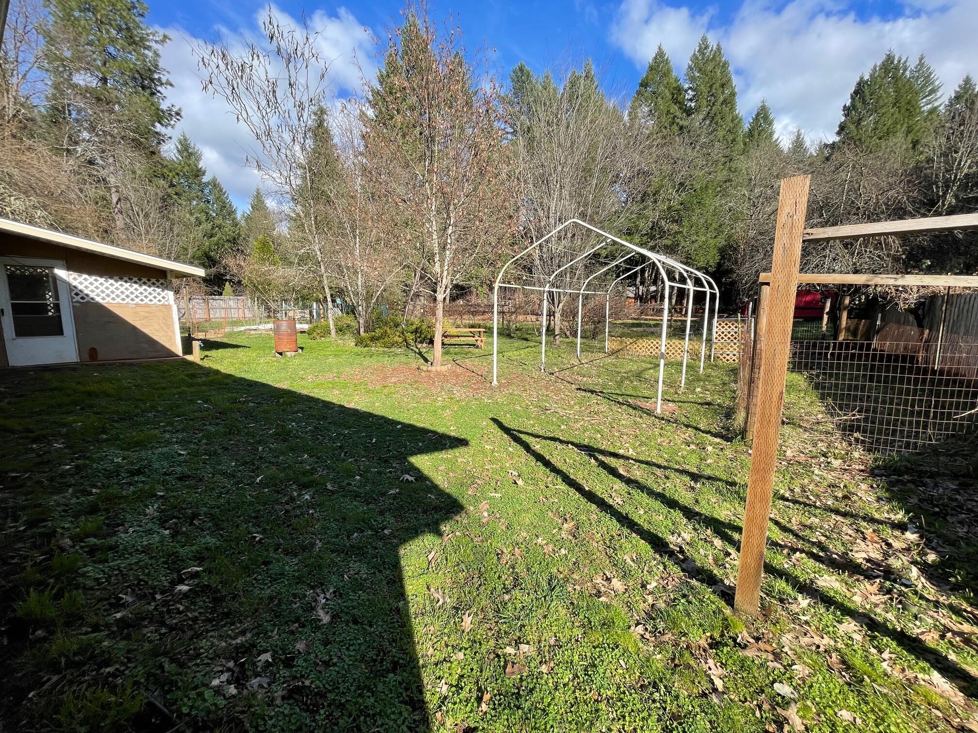 411 South Old Stage Road Cave Junction, OR 97523 - Photo 22 of 39 a view of a house with backyard