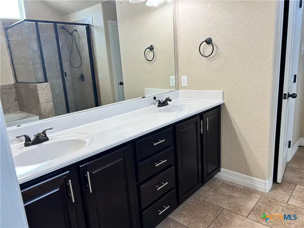 a bathroom with a tub and shower