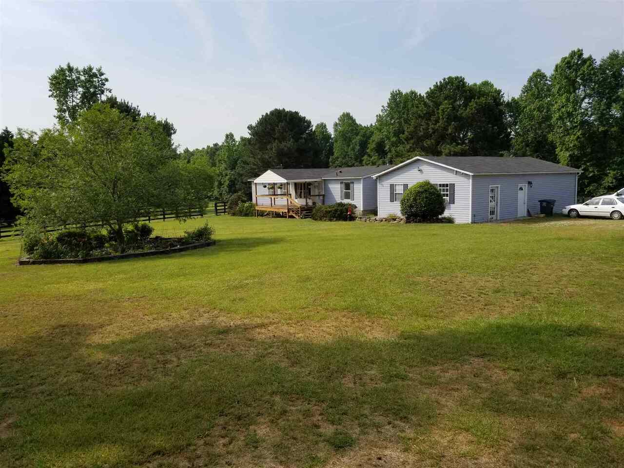 950 Garner Road Gay, GA 30218 - Photo 1 of 1 a front view of a house with a garden and yard