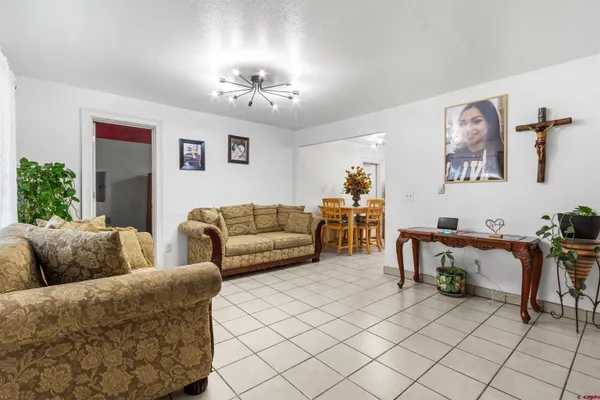 a living room with furniture and a chandelier
