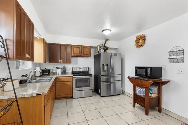 a kitchen with stainless steel appliances granite countertop a refrigerator stove and sink