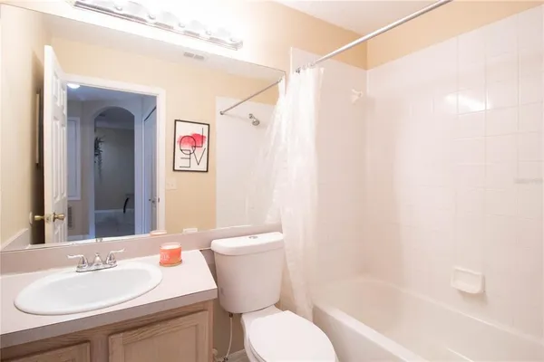 a white toilet sitting next to a bathroom sink