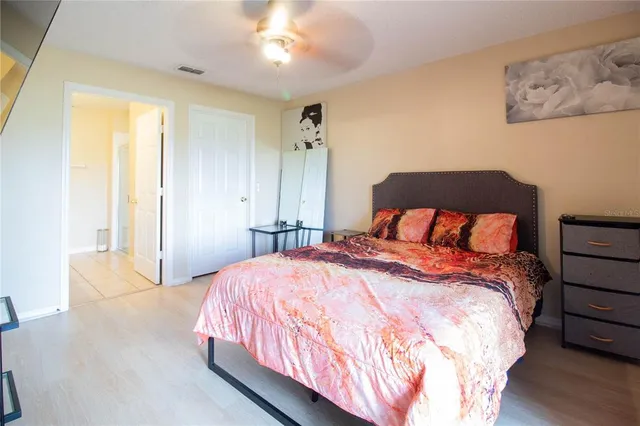 a bedroom with a bed and a night stand