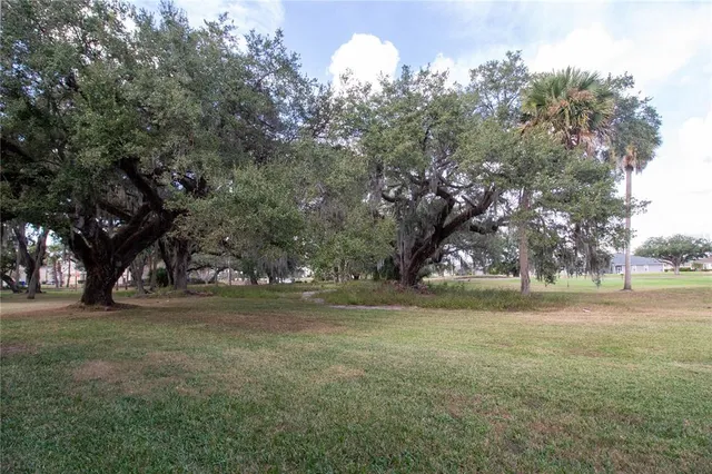 a view of a field with trees around