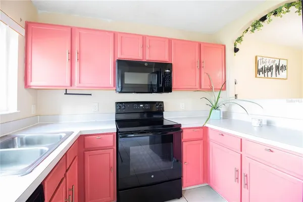 a kitchen with a sink stove and microwave
